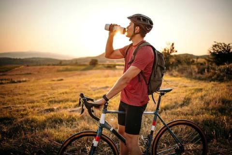 Man taking a water break on his bike